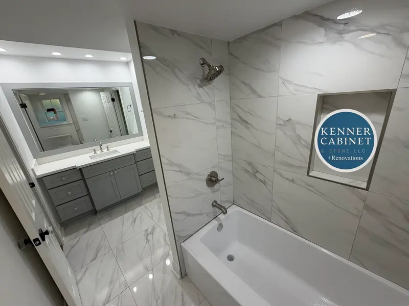 Bathroom with a tiled tub surround and vanity