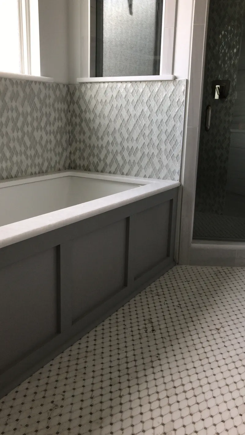 Tub with tiled surround and mosaic floor