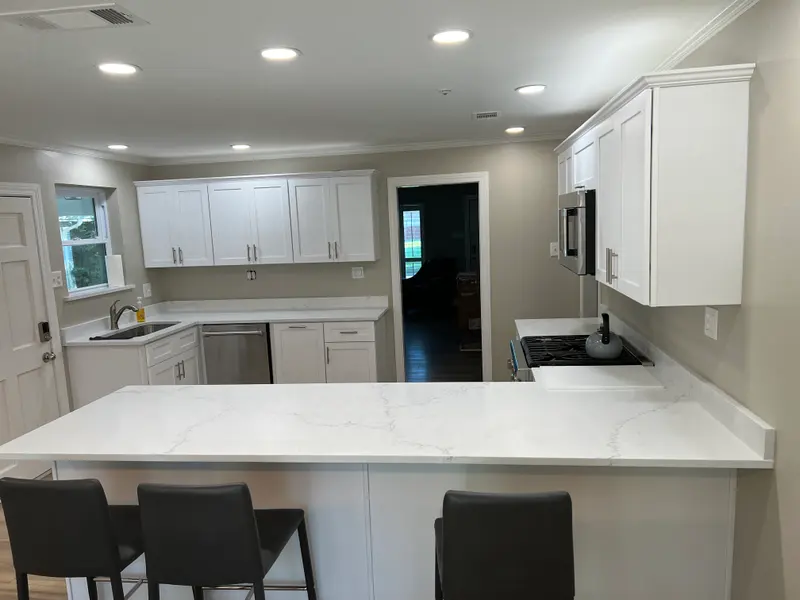Kitchen with gray island cabinets and white uppers
