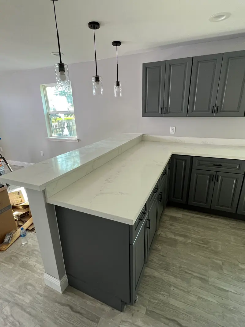 Gray shaker kitchen opening to the dining area