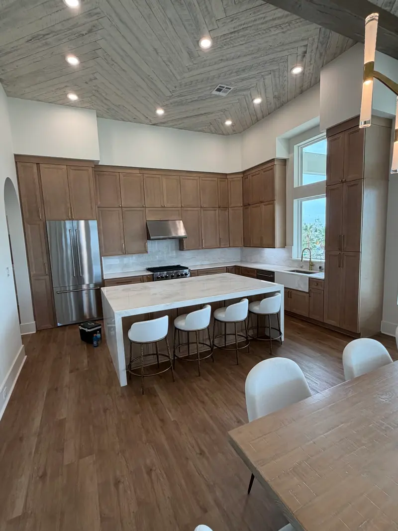 Open kitchen with white cabinets and a large island