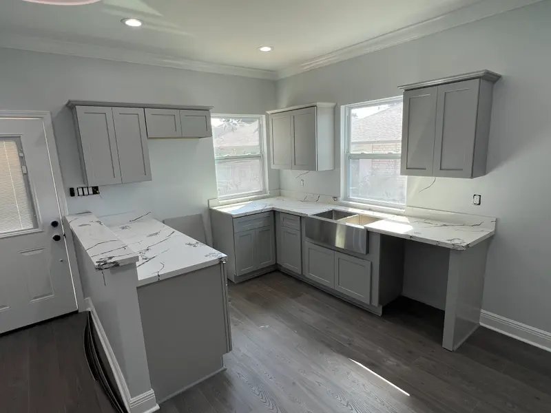 White shaker kitchen cabinets with a marble-look countertop