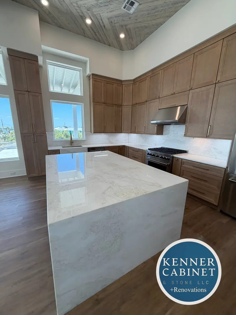 Kitchen with a wood island and white stone top